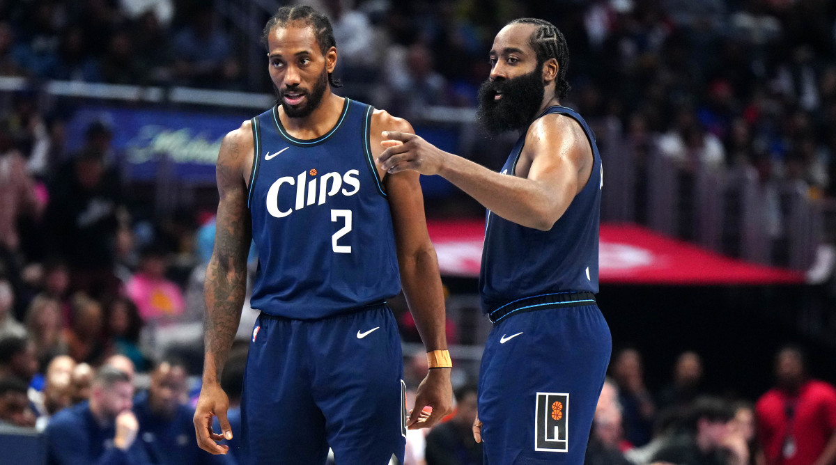 Clippers forward Kawhi Leonard and guard James Harden talk on the court during their game against the Pelicans.